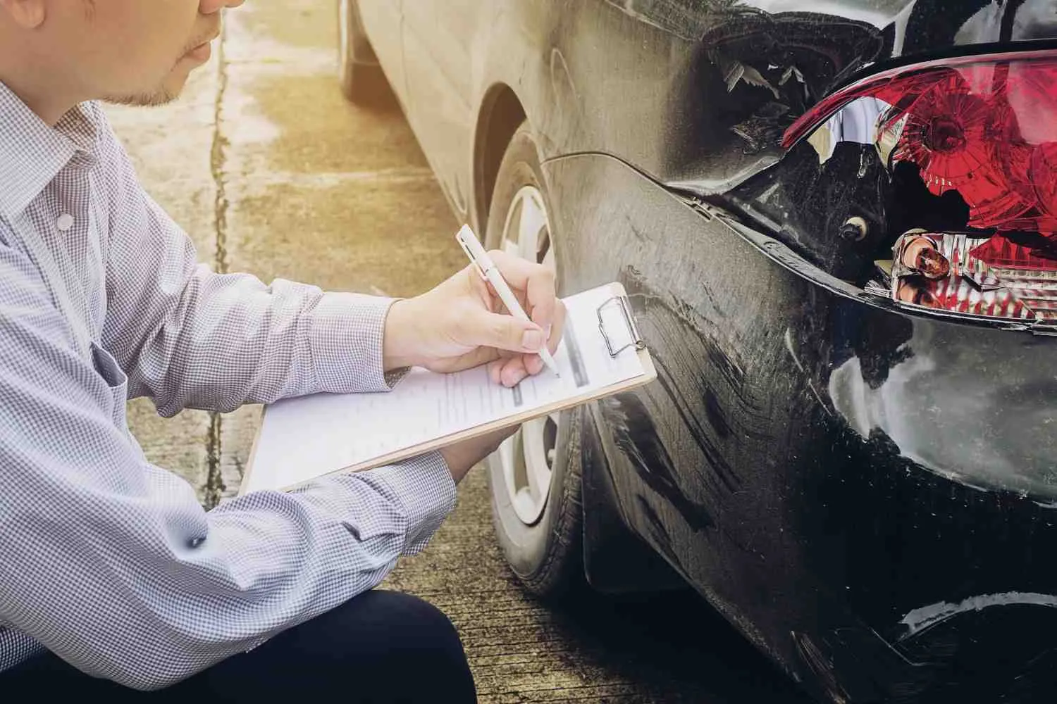 Notes being written beside a dented car panel